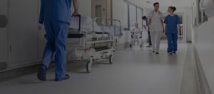 health care facility hallway with doctors and nurses walking