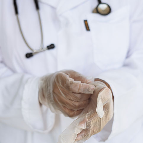 medical professional removing gloves