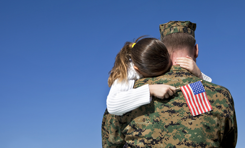 Military father holding daughter