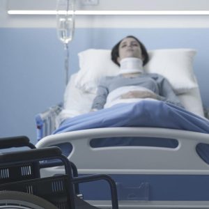 woman with spinal cord injury in hospital bed from highway car accident