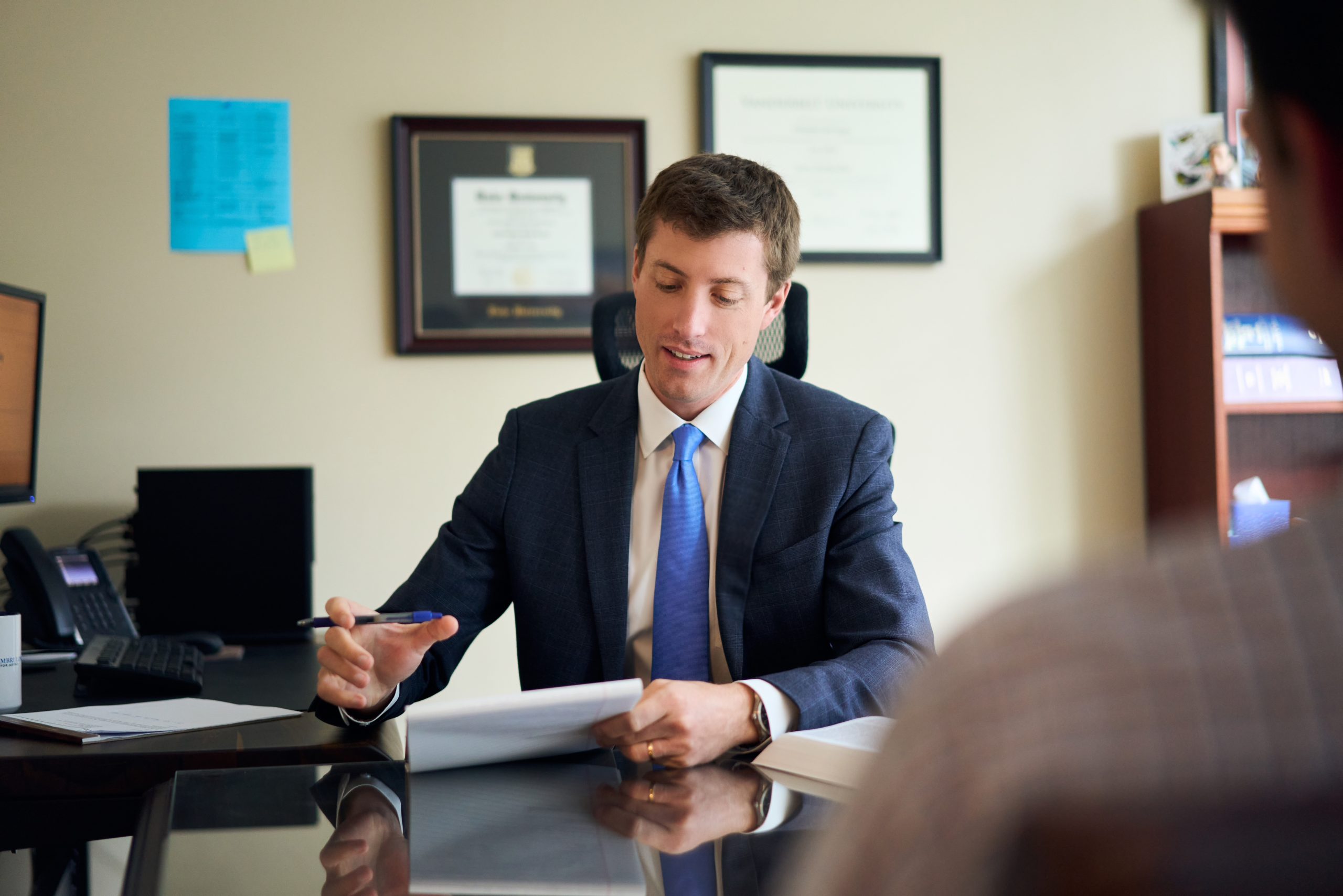 DC Car Accident Lawyer Christopher Regan discusses a case with a client in his Washington, DC office