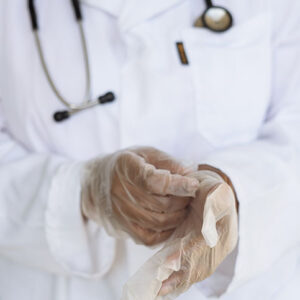doctor removing surgical gloves