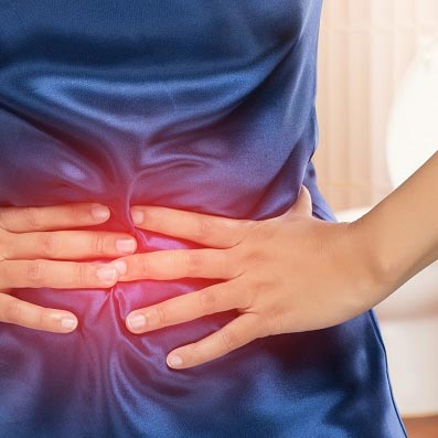 person clutching stomach in pain from food poisoning