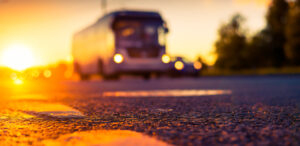 bus on road at sunset, bus accident lawyer