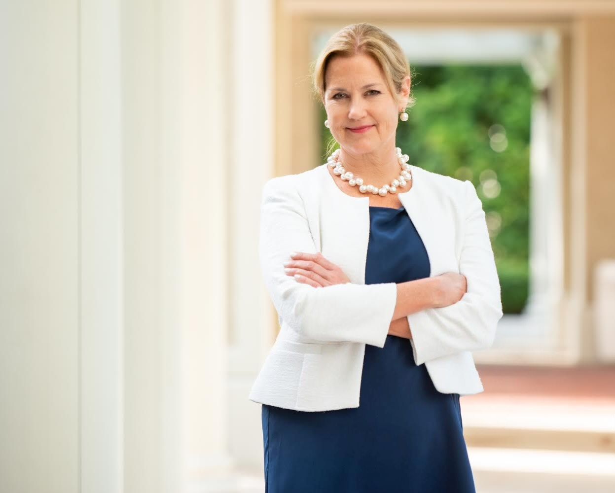 A professional female attorney stands confidently in front of a Maryland courthouse, dressed in formal attire with arms crossed and a composed expression. Her posture reflects expertise in handling complex medical malpractice cases, including those affected by state caps on noneconomic damages. These legal limits influence compensation awarded for pain, suffering, and emotional distress in Maryland malpractice claims. Clients trust experienced lawyers to navigate these challenges and fight for fair outcomes. For legal guidance, contact Regan Zambri Long PLLC at (202) 937-3310.