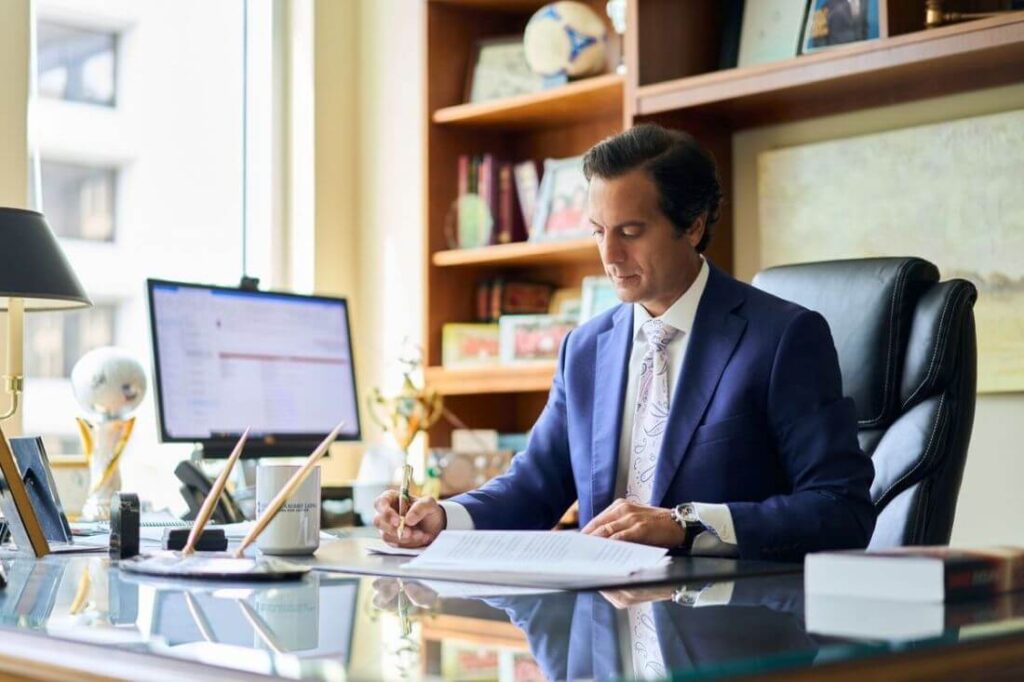 Salvatore Zambri, a top-rated DC Lyft accident lawyer at Regan Zambri Long PLLC, reviews legal documents at his office in Washington, DC. Specializing in Lyft accident claims and personal injury cases, Mr. Zambri offers strategic legal counsel and representation for clients injured while using rideshare services.